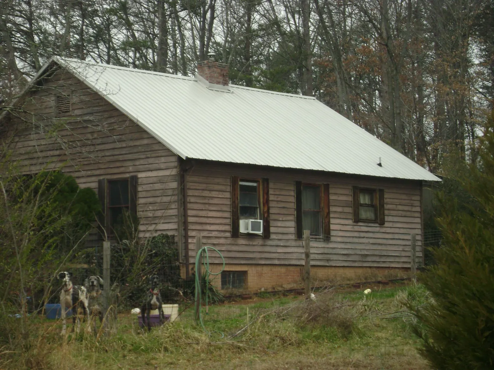 White metal roof on an old wood sided farmhouse, from a Metal Roof Installation job in Manito
